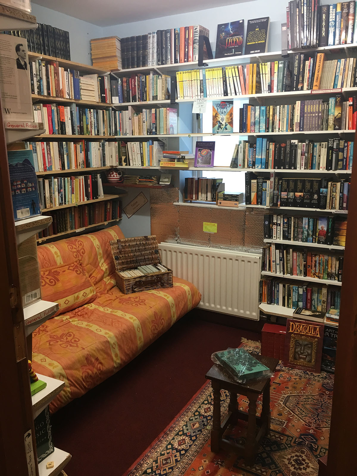 The fiction snug at Beckside Books, with two sofas and a window onto St Andrew's Churchyard